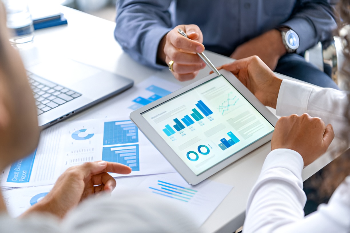 three professionals discussing business financial data